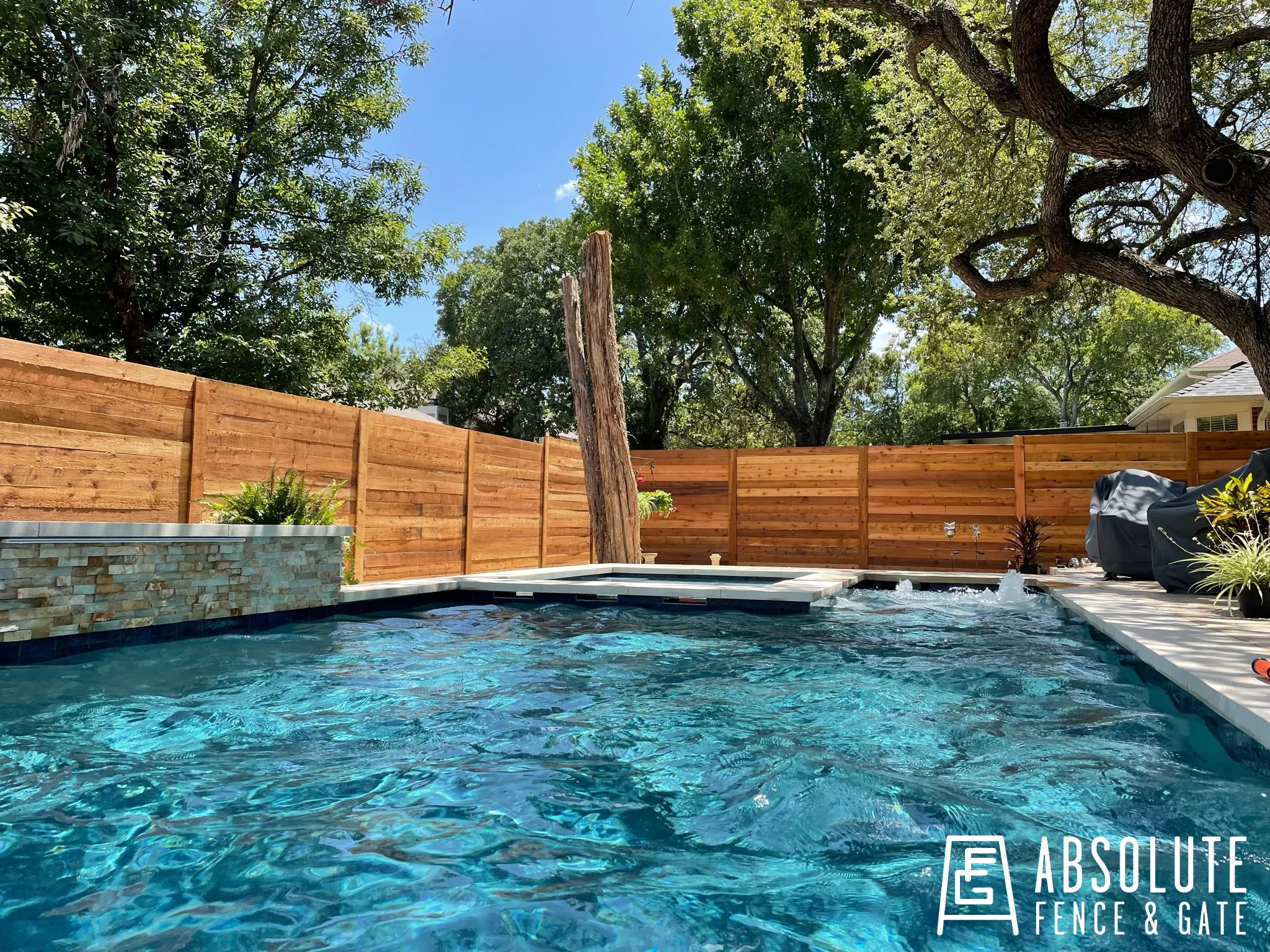 Horizontal cedar privacy fence around pool by Absolute Fence & Gate in Austin
