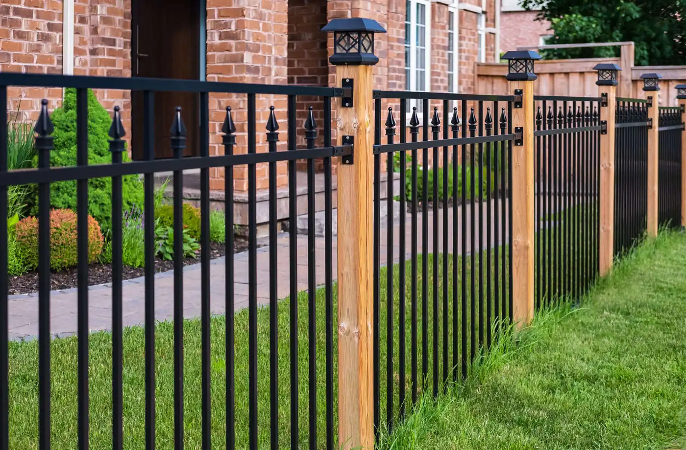 Ornamental steel fence with wood posts in Pflugerville, TX
