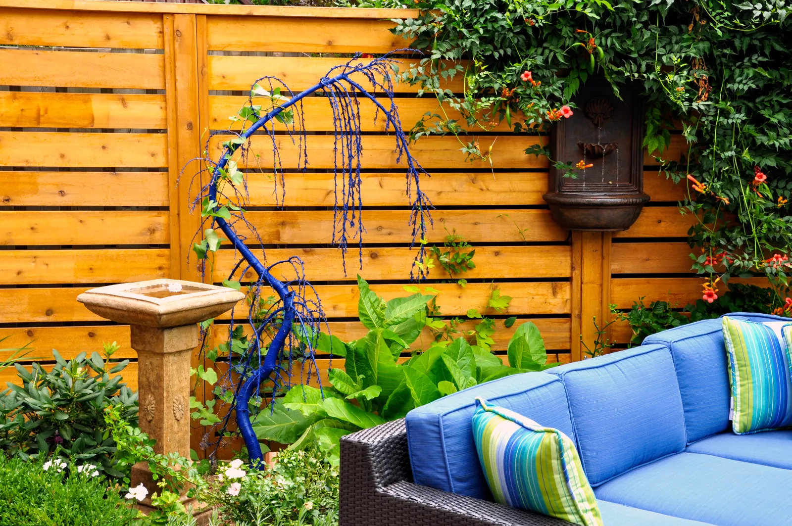 Horizontal cedar privacy fence behind a landscaped backyard seating area